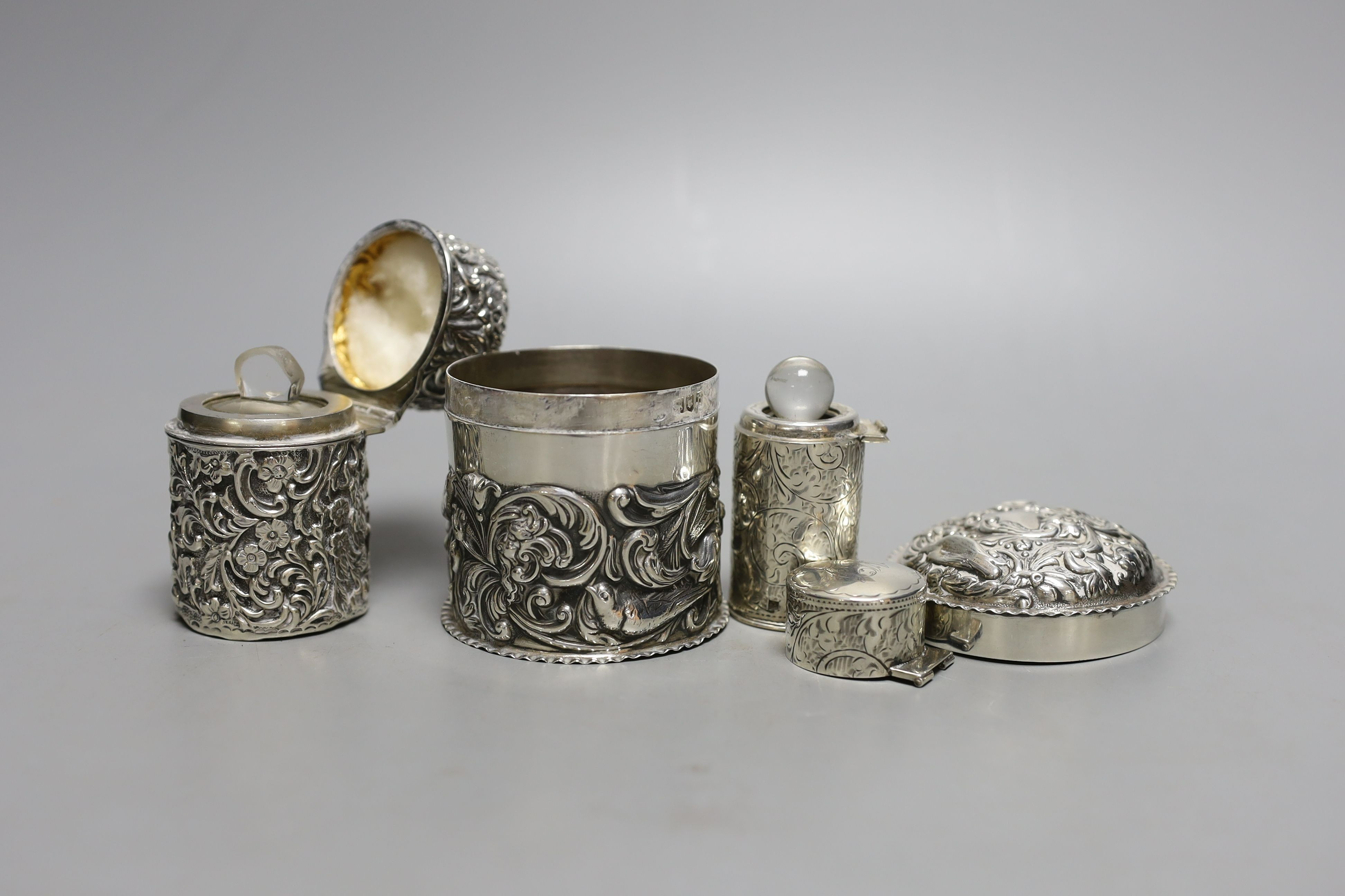 Two Edwardian silver mounted scent bottles, London, 1907, tallest 69mm and a silver embossed box and cover.